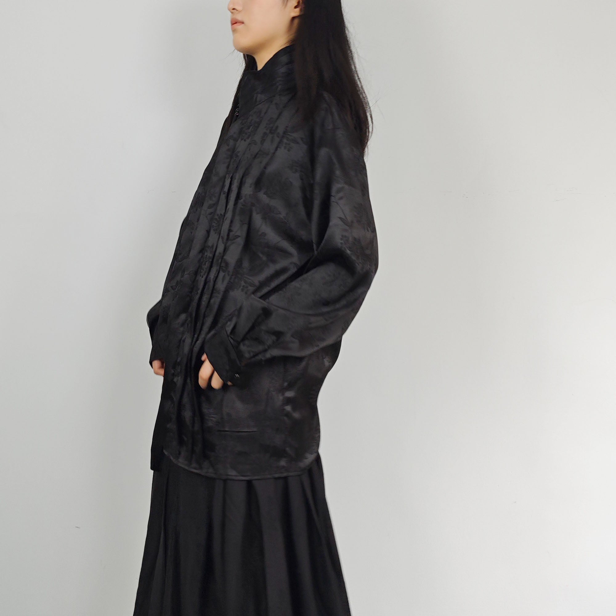 High collar black shirt pleated front details black monochrome jacquard fabric