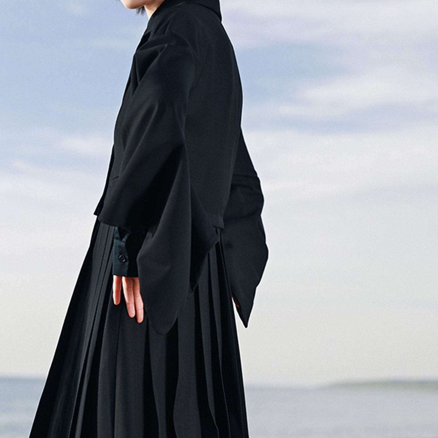Suit dress with squared sleeves and pleated skirt Black suiting fabric dress
